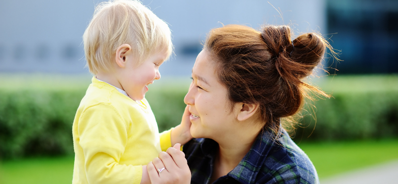 asian woman and blonde child